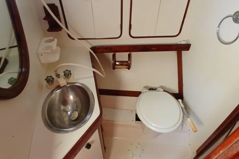 Slide: The Image of 1981 Gulfstar 44 yacht bathroom with sink, toilet, and wooden accents. - 35