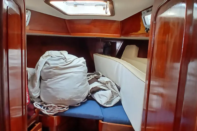 Slide: The Image of Interior cabin of 1981 Gulfstar 44 sailboat with wooden finish and stored sails. - 38
