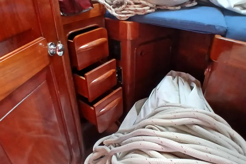 Slide: The Image of Interior of 1981 Gulfstar 44 sailboat with wooden drawers and coiled rope. - 40