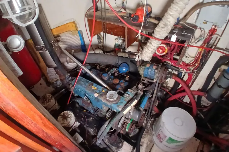 Slide: The Image of Engine room of a 1981 Gulfstar 44 sailboat, featuring mechanical components and wiring. - 43