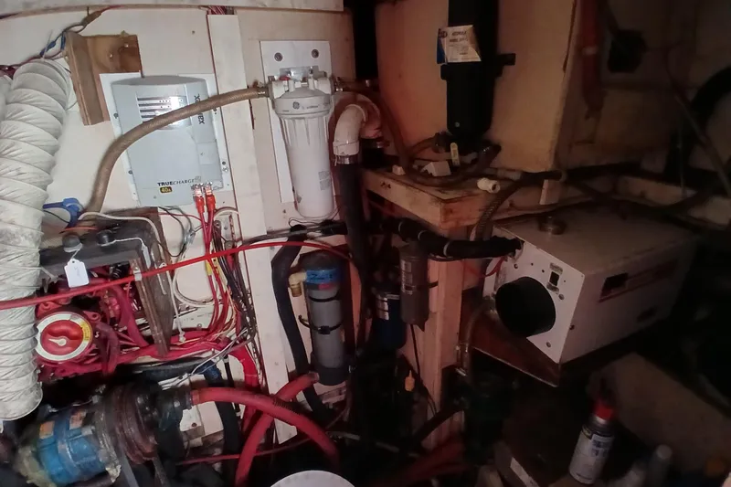Slide: The Image of Engine room of a 1981 Gulfstar 44 yacht, featuring various mechanical components and wiring. - 44