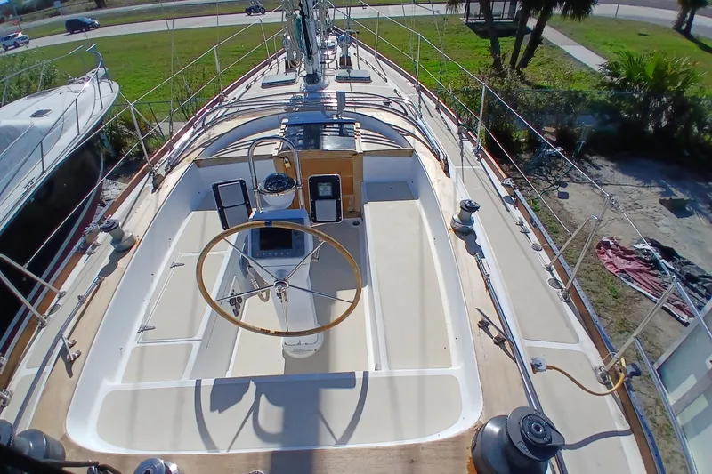 Slide: The Image of 1981 Gulfstar 44 sailboat cockpit with wooden wheel and navigation instruments. - 48