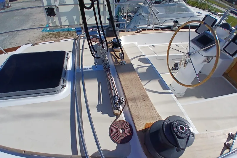 Slide: The Image of Cockpit of 1981 Gulfstar 44 sailboat with steering wheel and winch. - 51