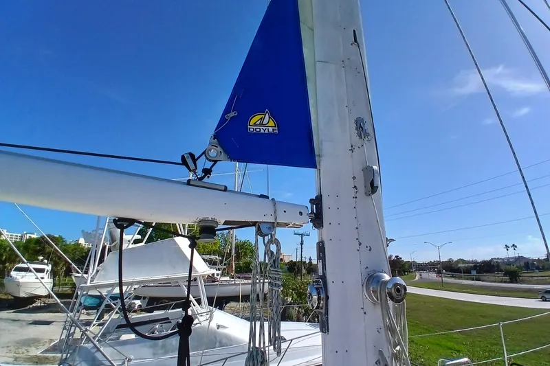 Slide: The Image of 1981 Gulfstar 44 sailboat mast and rigging with Doyle sail under clear blue sky. - 56