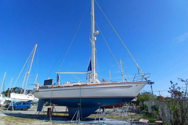 Slide: The Image of 1981 Gulfstar 44 sailboat on stands under clear blue sky. - 58