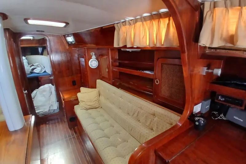 Slide: The Image of Interior of 1981 Gulfstar 44 yacht with wooden finish and cozy seating area. - 6