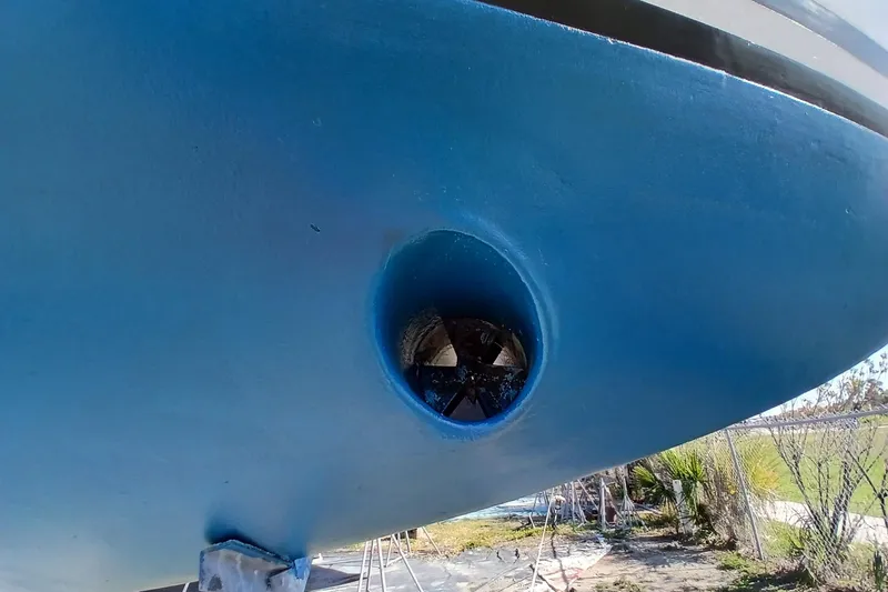 Slide: The Image of Bow thruster on a 1981 Gulfstar 44 sailboat, painted blue, on land. - 60