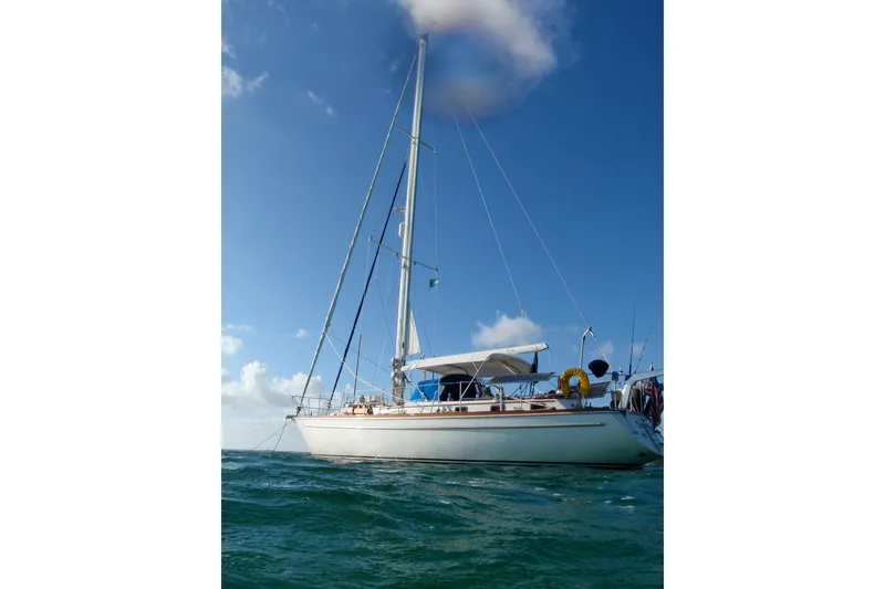 Slide: The Image of 1981 Gulfstar 44 sailboat on open water under a clear blue sky. - 67
