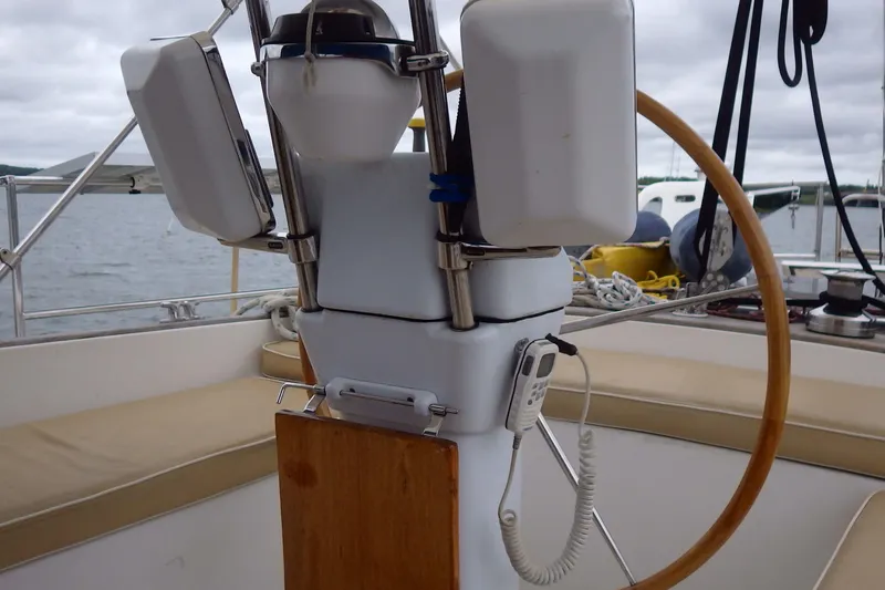 Slide: The Image of Cockpit of 1981 Gulfstar 44 sailboat with wooden steering wheel and navigation equipment. - 69