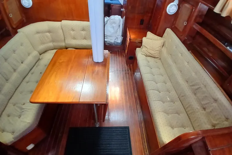 Slide: The Image of 1981 Gulfstar 44 yacht interior with wooden table and cushioned seating. - 7