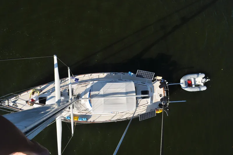Slide: The Image of Aerial view of 1981 Gulfstar 44 sailboat with dinghy, on calm water. - 70