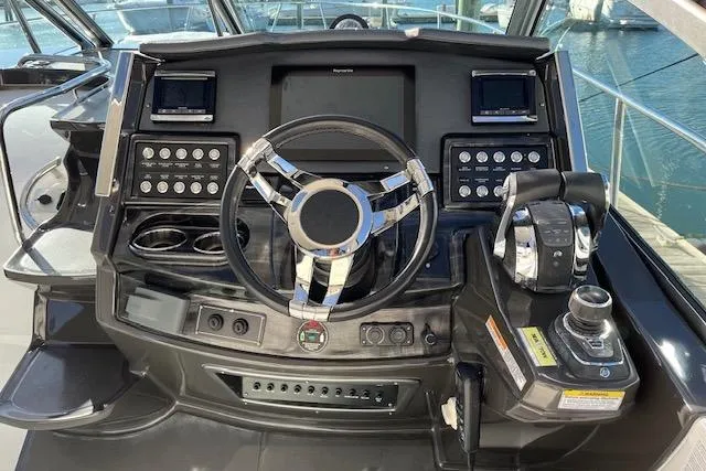 Slide: The Image of Cockpit of 2019 Monterey 355 Sport Yacht with modern controls and steering wheel. - 10