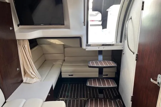 Slide: The Image of Interior of a 2019 Monterey 355 Sport Yacht with seating, stairs, and a mounted TV. - 11