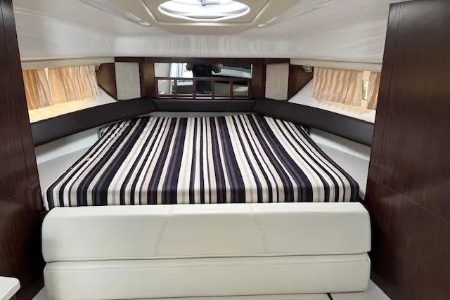 Slide: The Image of Interior cabin of 2019 Monterey 355 Sport Yacht with striped bedding and modern design. - 15