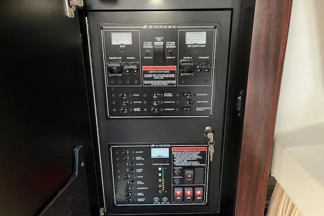 Slide: The Image of Electrical control panel inside 2019 Monterey 355 Sport Yacht, featuring switches and indicators. - 18