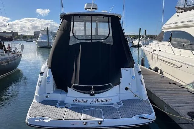 Slide: The Image of 2019 Monterey 355 Sport Yacht docked, rear view with black cover, named "Swiss Manatee". - 2
