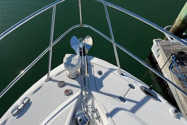 Slide: The Image of Bow view of 2019 Monterey 355 Sport Yacht with anchor and railing, docked by wooden pier. - 5