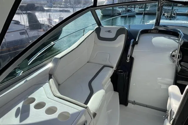 Slide: The Image of 2019 Monterey 355 Sport Yacht interior with sleek seating and cup holders, docked at marina. - 9