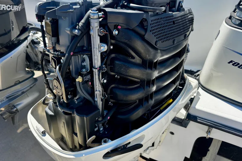 Slide: The Image of Close-up of a 2000 Glacier Bay 2670 Isle Runner outboard motor, showcasing engine details. - 11
