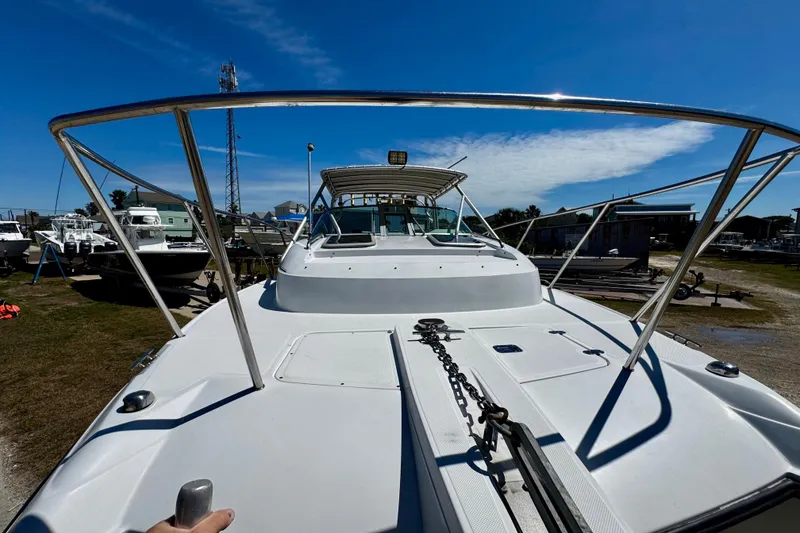 Slide: The Image of 2000 Glacier Bay 2670 Isle Runner boat docked under clear blue sky. - 13