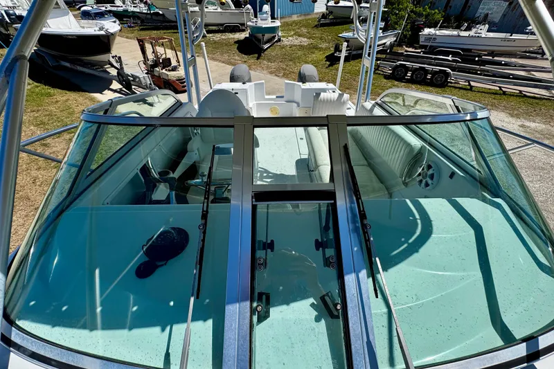 Slide: The Image of 2000 Glacier Bay 2670 Isle Runner boat with open cockpit and seating, docked outdoors. - 16