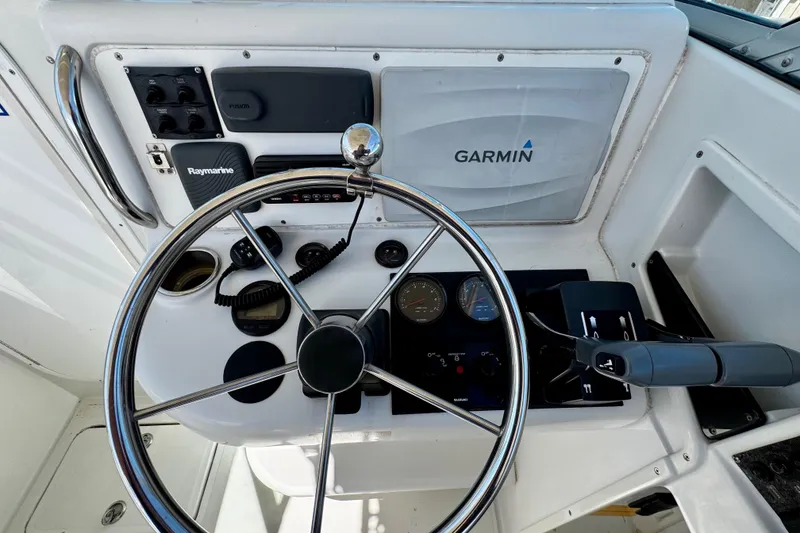 Slide: The Image of Steering console of 2000 Glacier Bay 2670 Isle Runner with Garmin and Raymarine equipment. - 20