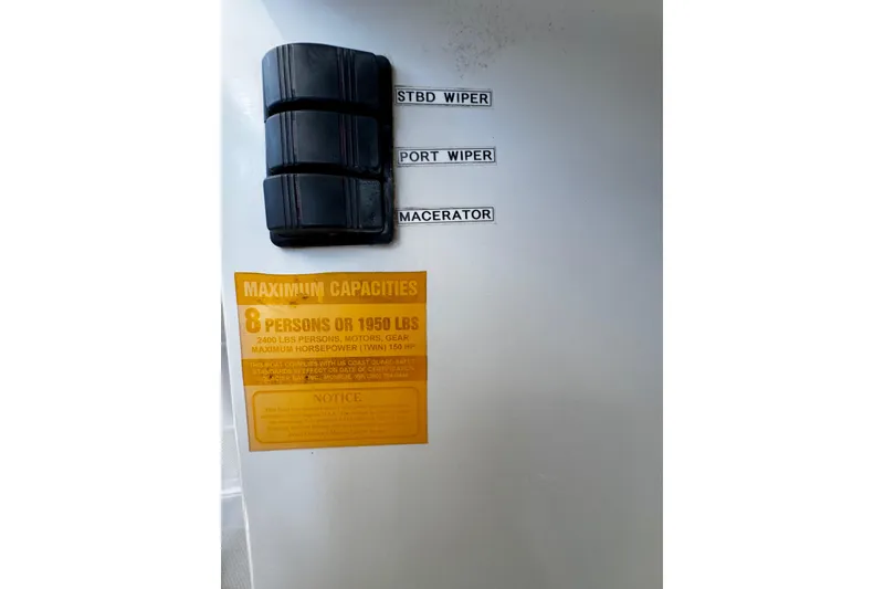 Slide: The Image of Control panel of a 2000 Glacier Bay 2670 Isle Runner, showing wiper and macerator switches. - 22