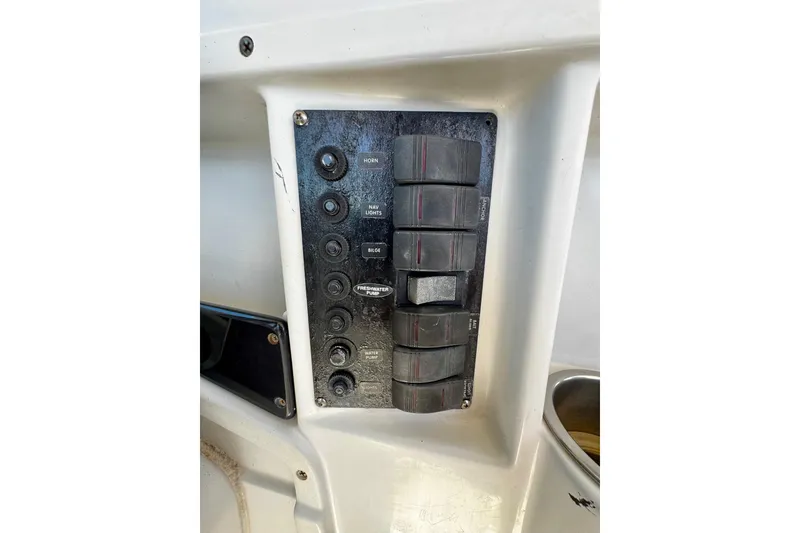 Slide: The Image of Control panel of 2000 Glacier Bay 2670 Isle Runner boat with labeled switches. - 23