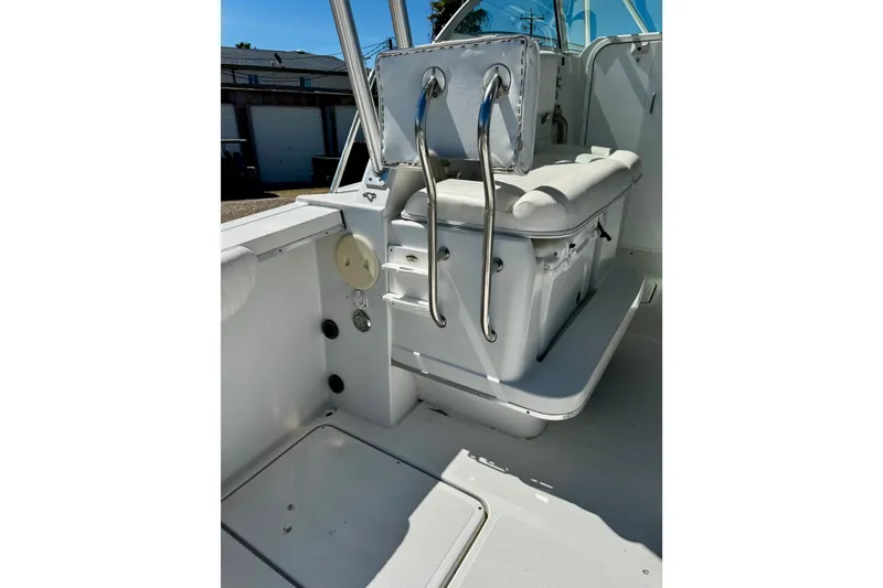 Slide: The Image of 2000 Glacier Bay 2670 Isle Runner boat interior with cushioned seating and stainless steel railings. - 28