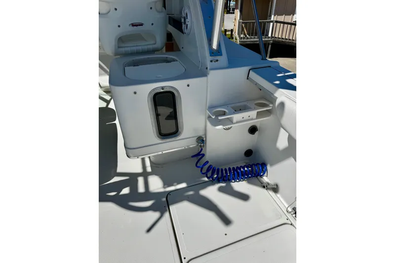 Slide: The Image of Interior view of a 2000 Glacier Bay 2670 Isle Runner boat, featuring seating and storage. - 29