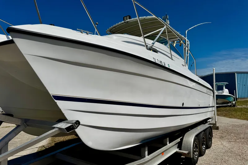Slide: The Image of 2000 Glacier Bay 2670 Isle Runner boat on trailer under clear blue sky. - 3
