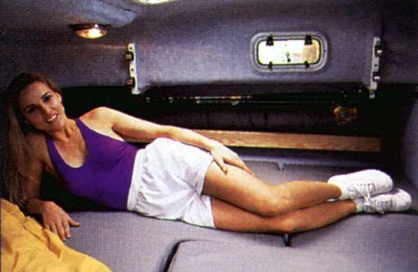 Slide: The Image of Woman relaxing in the cabin of a 2000 Glacier Bay 2670 Isle Runner. - 33