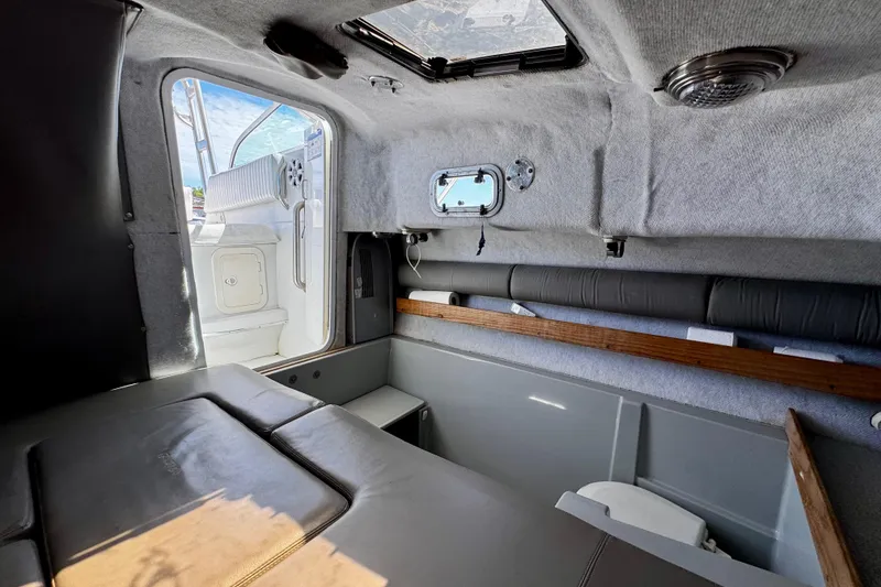 Slide: The Image of Interior cabin of 2000 Glacier Bay 2670 Isle Runner boat, featuring seating and storage. - 36