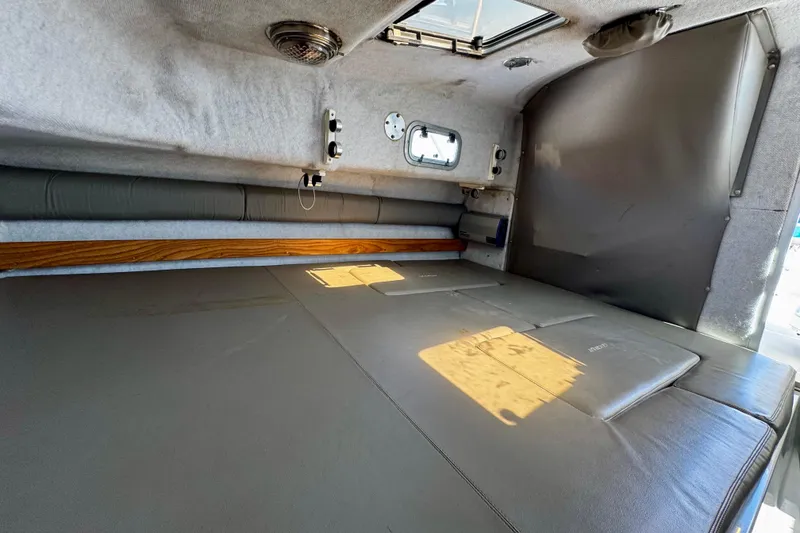 Slide: The Image of Interior cabin of 2000 Glacier Bay 2670 Isle Runner boat, featuring a cozy sleeping area. - 38