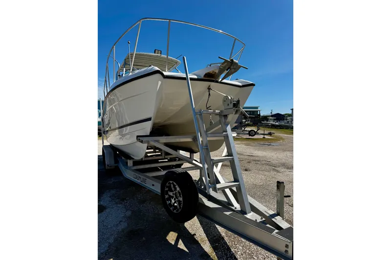 Slide: The Image of 2000 Glacier Bay 2670 Isle Runner boat on trailer under clear blue sky. - 5