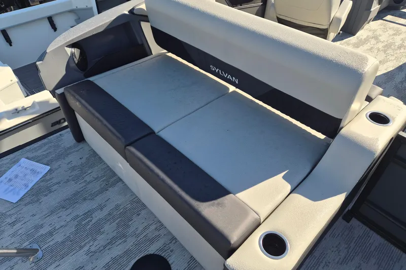 Slide: The Image of 2026 Sylvan R-22 CLZ DH boat interior with cushioned seating and cup holders. - 10