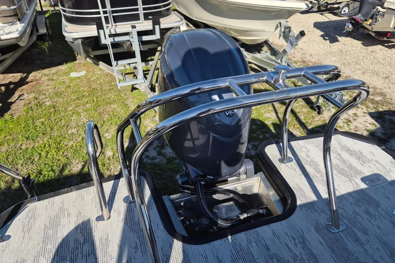 Slide: The Image of Rear view of 2026 Sylvan R-22 CLZ DH boat with outboard motor and chrome railing. - 13