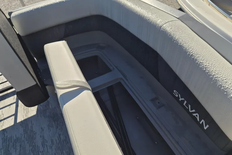 Slide: The Image of Interior seating of 2026 Sylvan R-22 CLZ DH boat with storage compartment. - 4