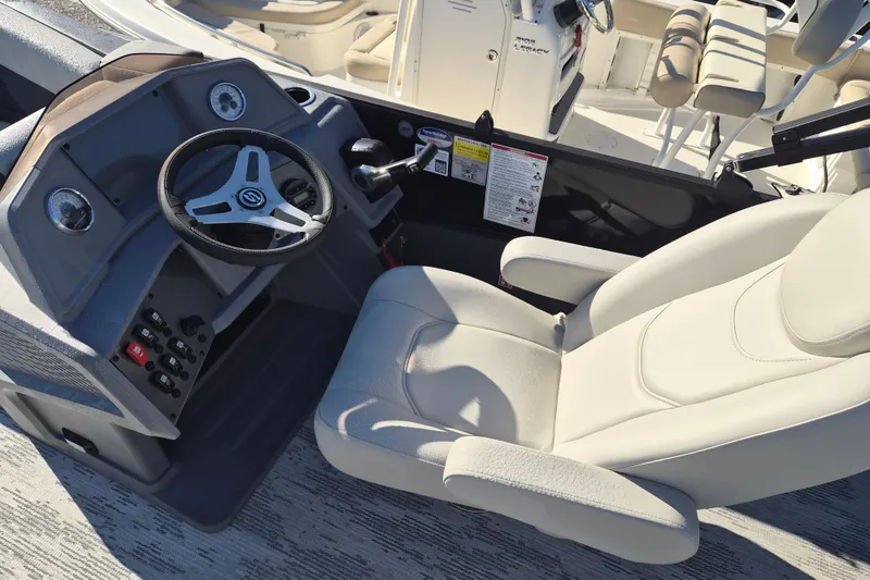 Slide: The Image of Captain's seat and helm of 2026 Sylvan R-22 CLZ DH boat, featuring modern controls. - 6