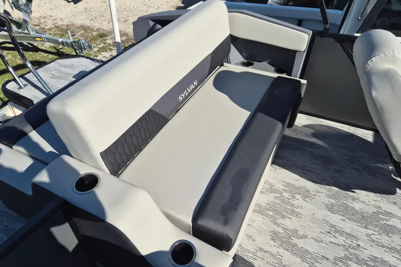 Slide: The Image of 2026 Sylvan R-22 CLZ DH boat interior with cushioned seating and cup holders. - 8