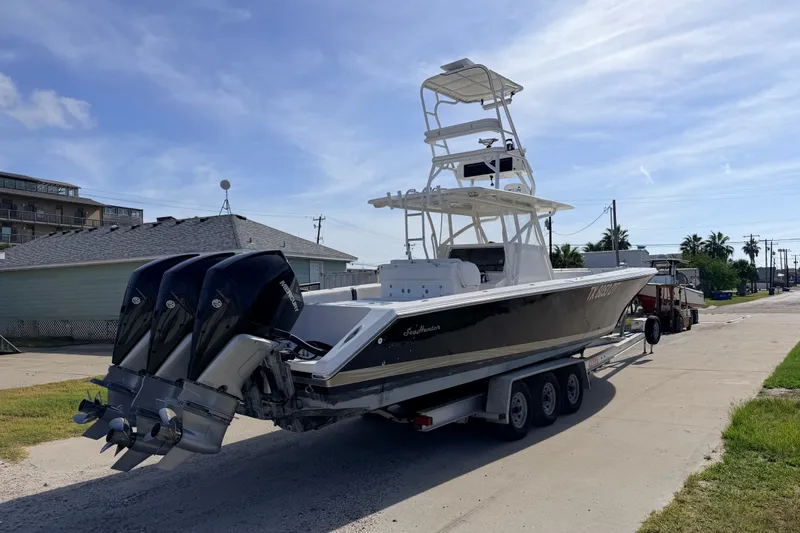 Slide: The Image of 2008 SeaHunter 40 Tournament boat on trailer with triple outboard engines. - 3