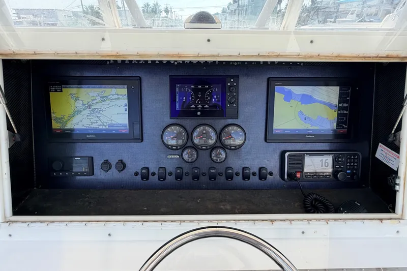 Slide: The Image of Dashboard of a 2008 SeaHunter 40 Tournament boat with navigation screens and controls. - 7