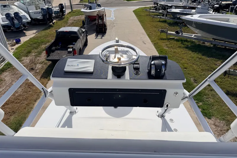 Slide: The Image of Helm of 2008 SeaHunter 40 Tournament boat with Garmin equipment, parked near other boats. - 31