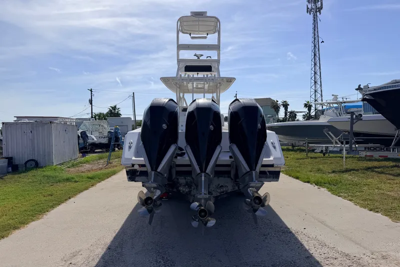 Slide: The Image of 2008 SeaHunter 40 Tournament boat with triple outboard engines, parked outdoors. - 4
