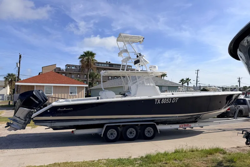 Slide: The Image of 2008 SeaHunter 40 Tournament boat on trailer, parked in residential area. - 1