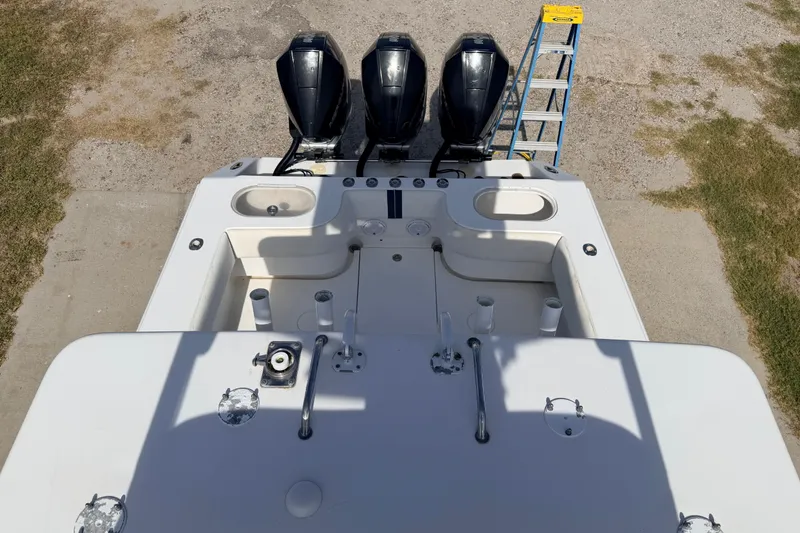 Slide: The Image of 2008 SeaHunter 40 Tournament boat with triple outboard engines and fishing setup. - 35