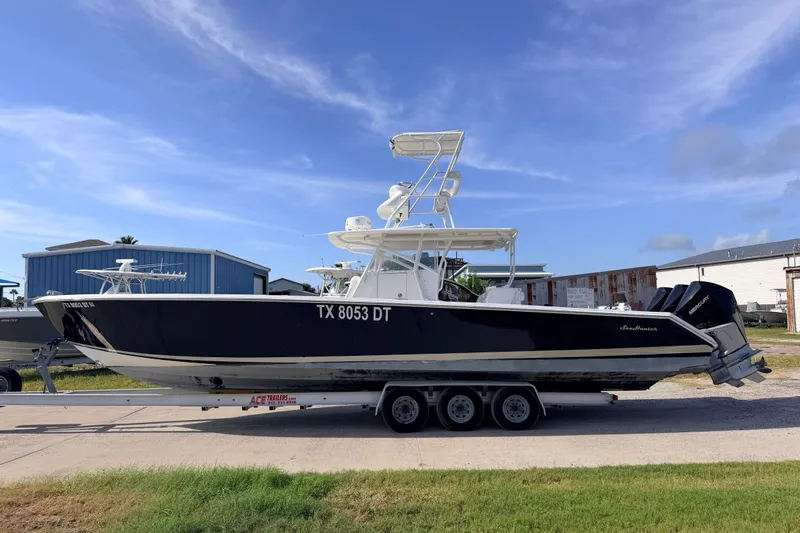 Slide: The Image of 2008 SeaHunter 40 Tournament boat on trailer, parked outdoors under blue sky. - 0