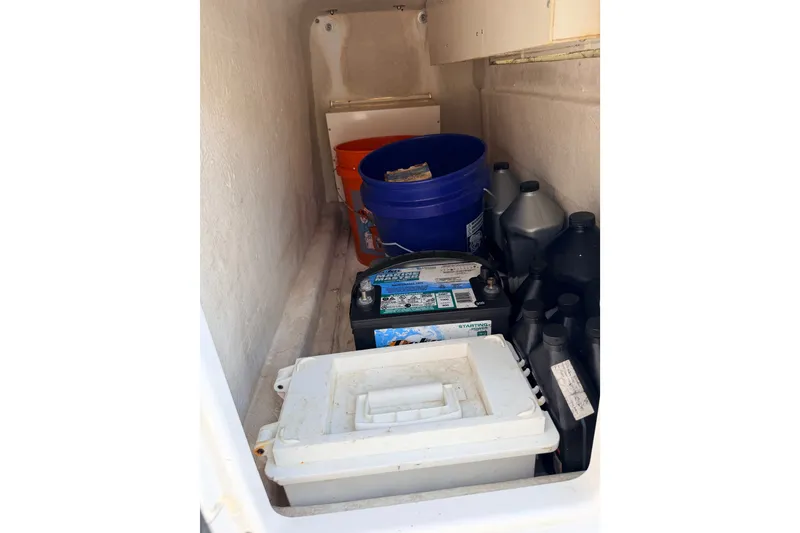 Slide: The Image of Storage compartment of 2008 SeaHunter 40 Tournament with buckets, battery, and oil containers. - 22