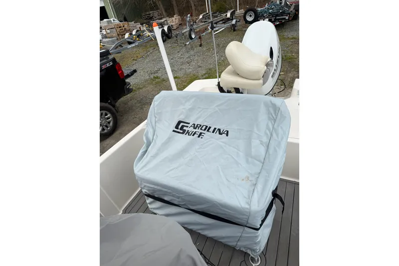 Slide: The Image of 2024 Carolina Skiff 192 JLS boat with covered console and seat on deck. - 15
