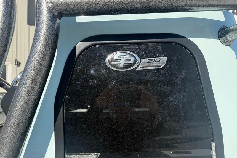 Slide: The Image of 2026 Sea Pro 210 Bay boat logo on a sleek black surface. - 10